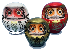 Daruma dolls in white, gold, and vermillion red